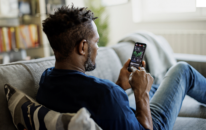 man looking at stocks on his phone