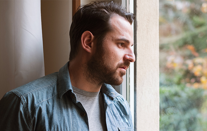 man looking out the window